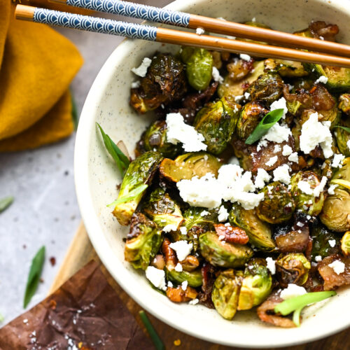 air fryer brussels sprouts with goat cheese in a white bowl.