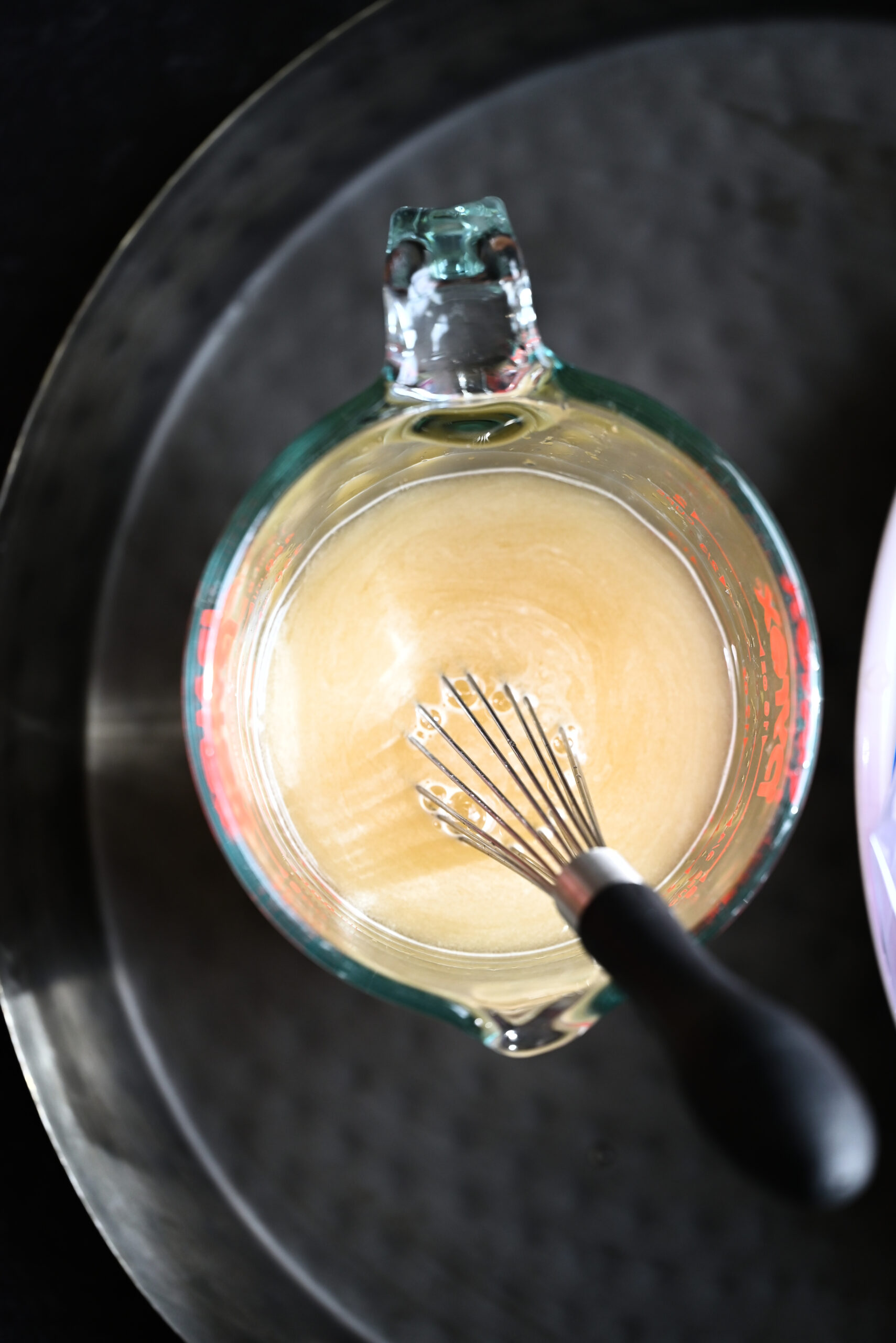 Process shot of the water, brown sugar, sea salt, and ACV being whisked together. 