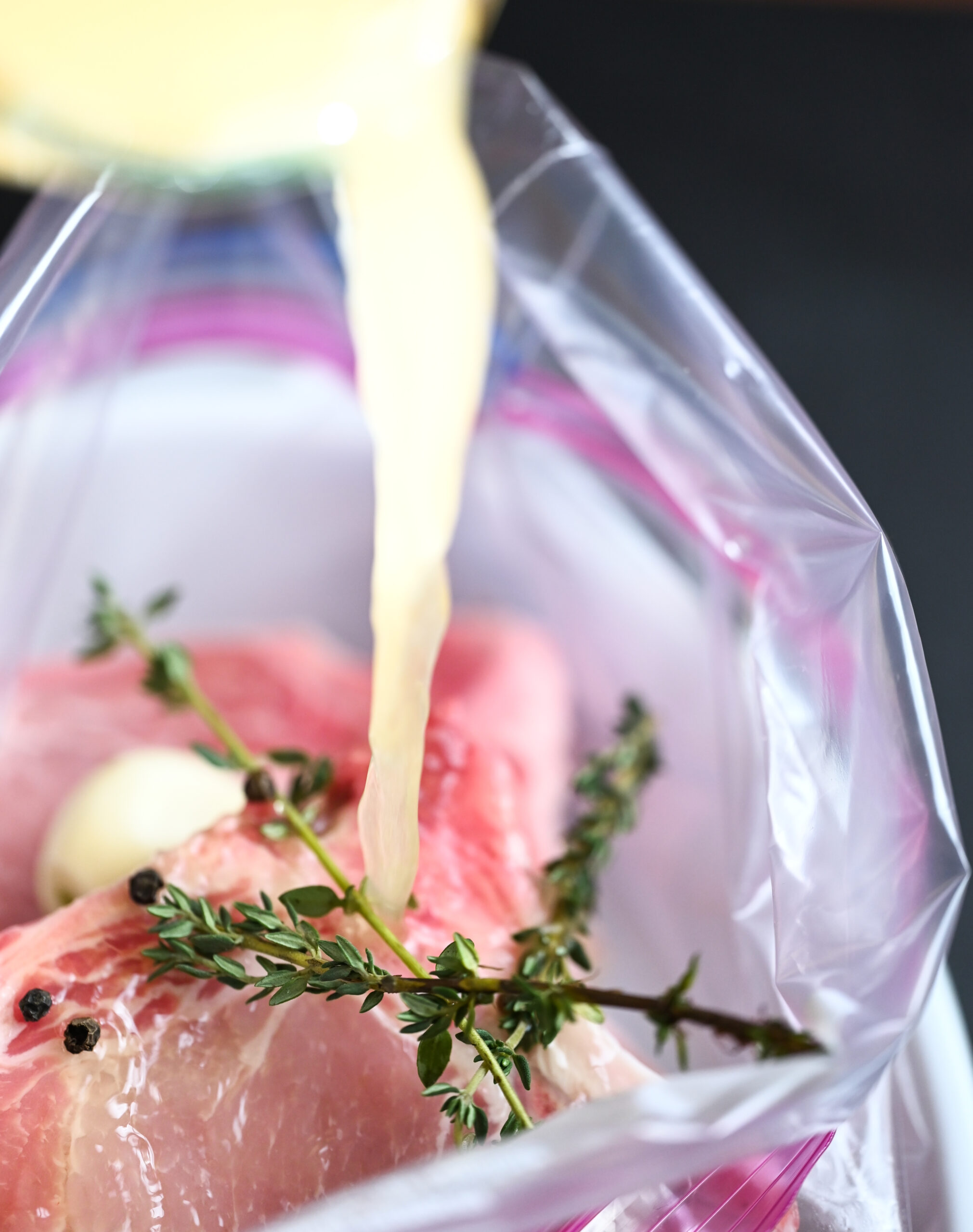 Process photo of the brine going into the bag of pork chops. 