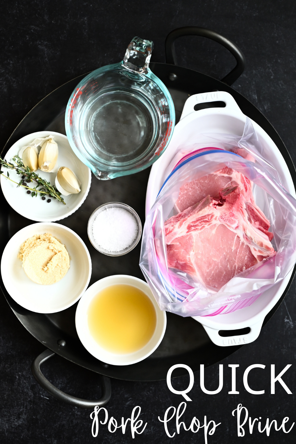 Ingredient shot for quick pork chop brine containing: pork, water, brown sugar, sea salt, garlic, ACV, peppercorns, and rosemary sprigs. 