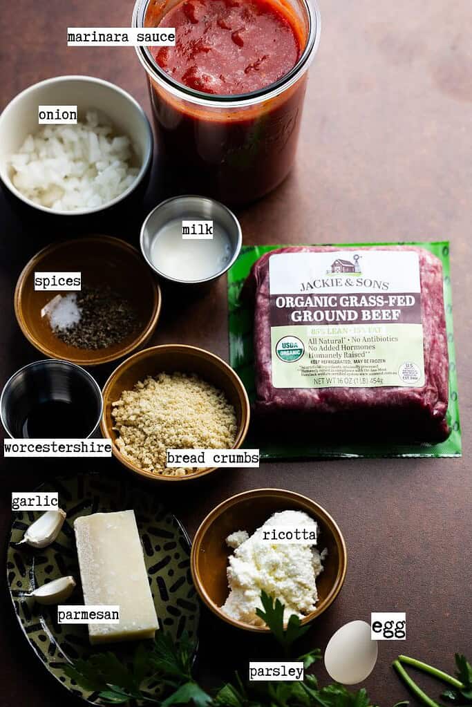 Ingredients needed to make dutch oven meatballs in tomato sauce with labels.