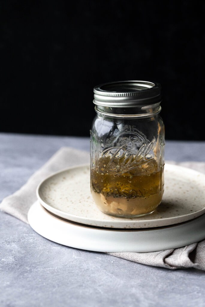Creamy hummus dressing in a mason jar.