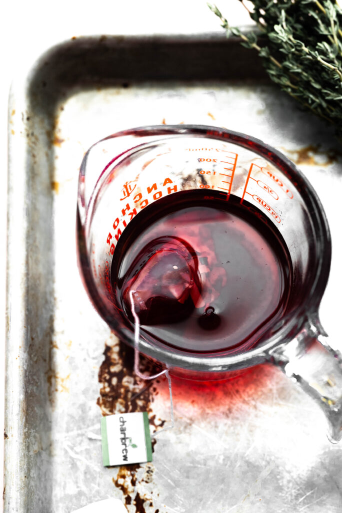 Strongly brewed rose tea in a pyrex glass. 