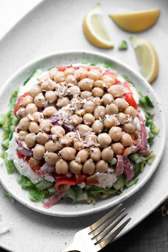Photo of the La Scala Salad served "La Scala Style" on a plate with chickpeas on top. 