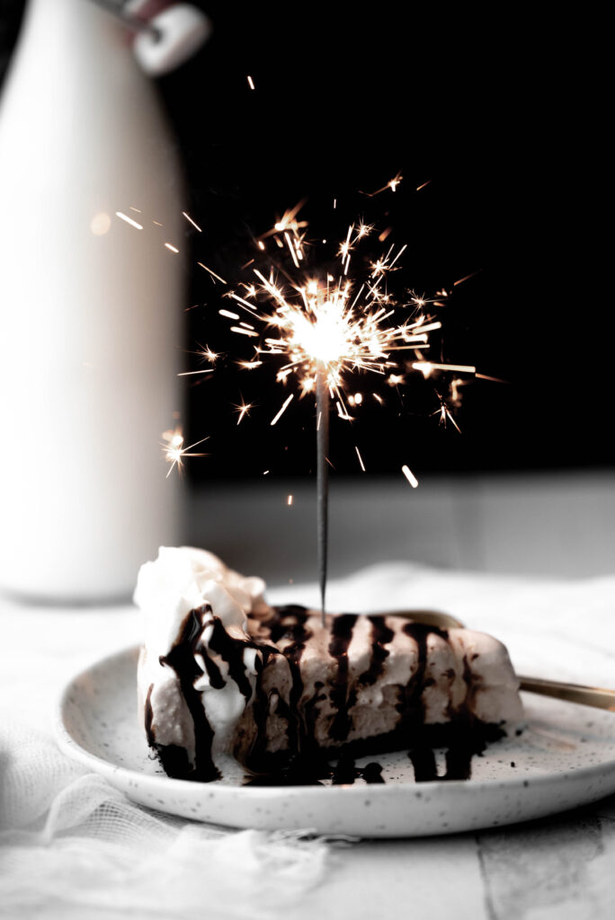 Billy Miner Pie with a sparkler candle and chocolate drizzle. 