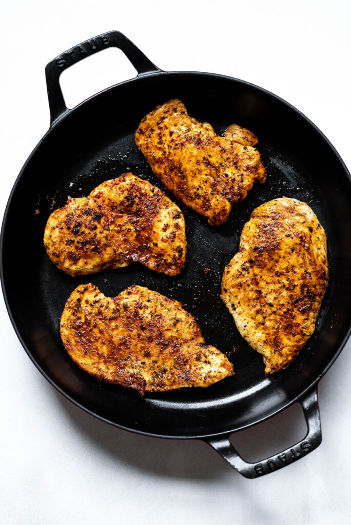 cooked chicken in a black pan. 