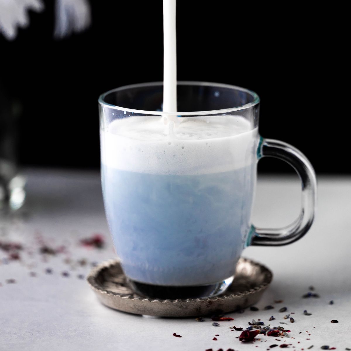 butterfly pea latte with foam on a white background