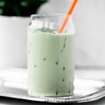 hero image of dunkin iced matcha latte - tall glass with matcha, ice and an orange straw.