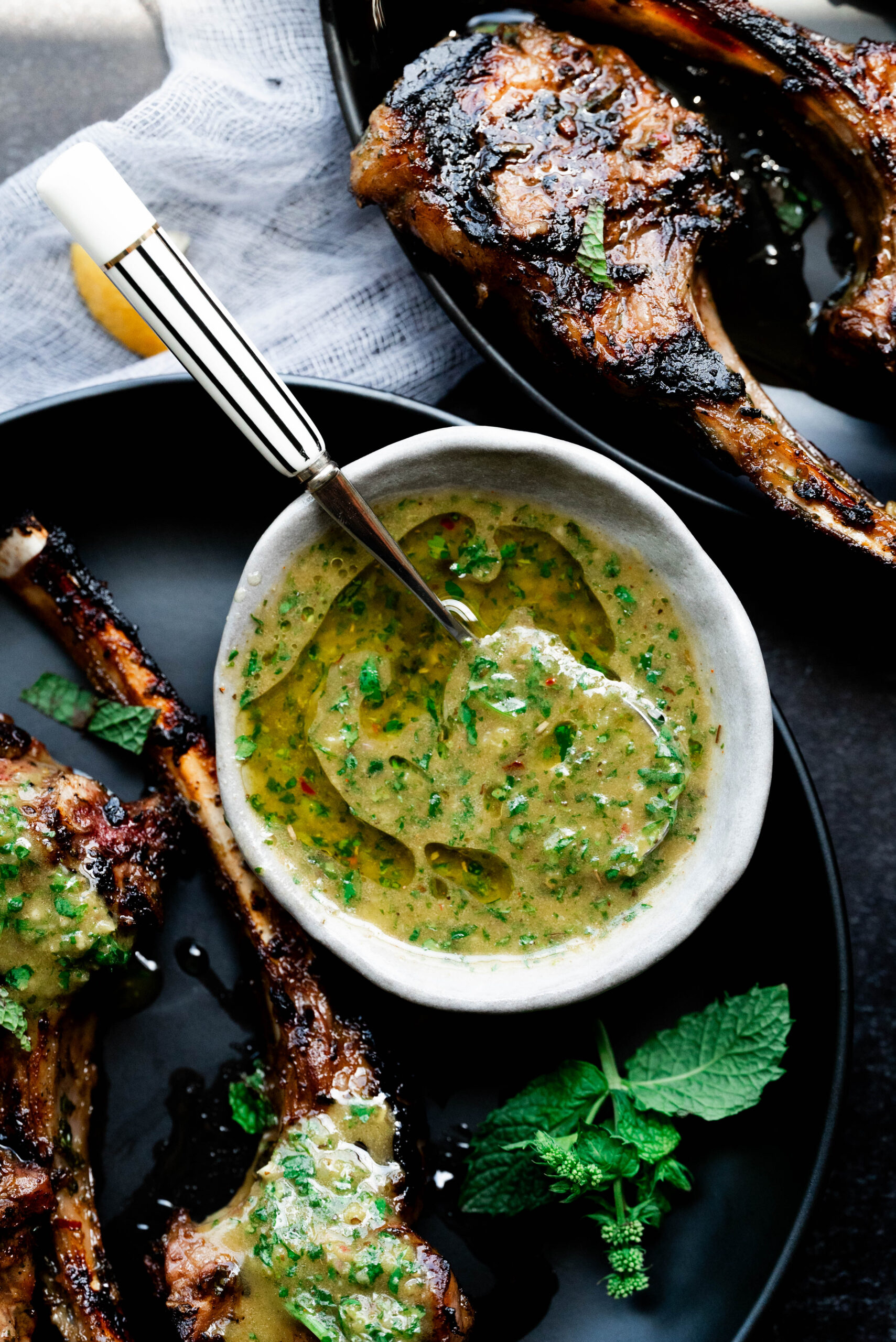 Lamb chops with mint dipping sauce in a bowl. 