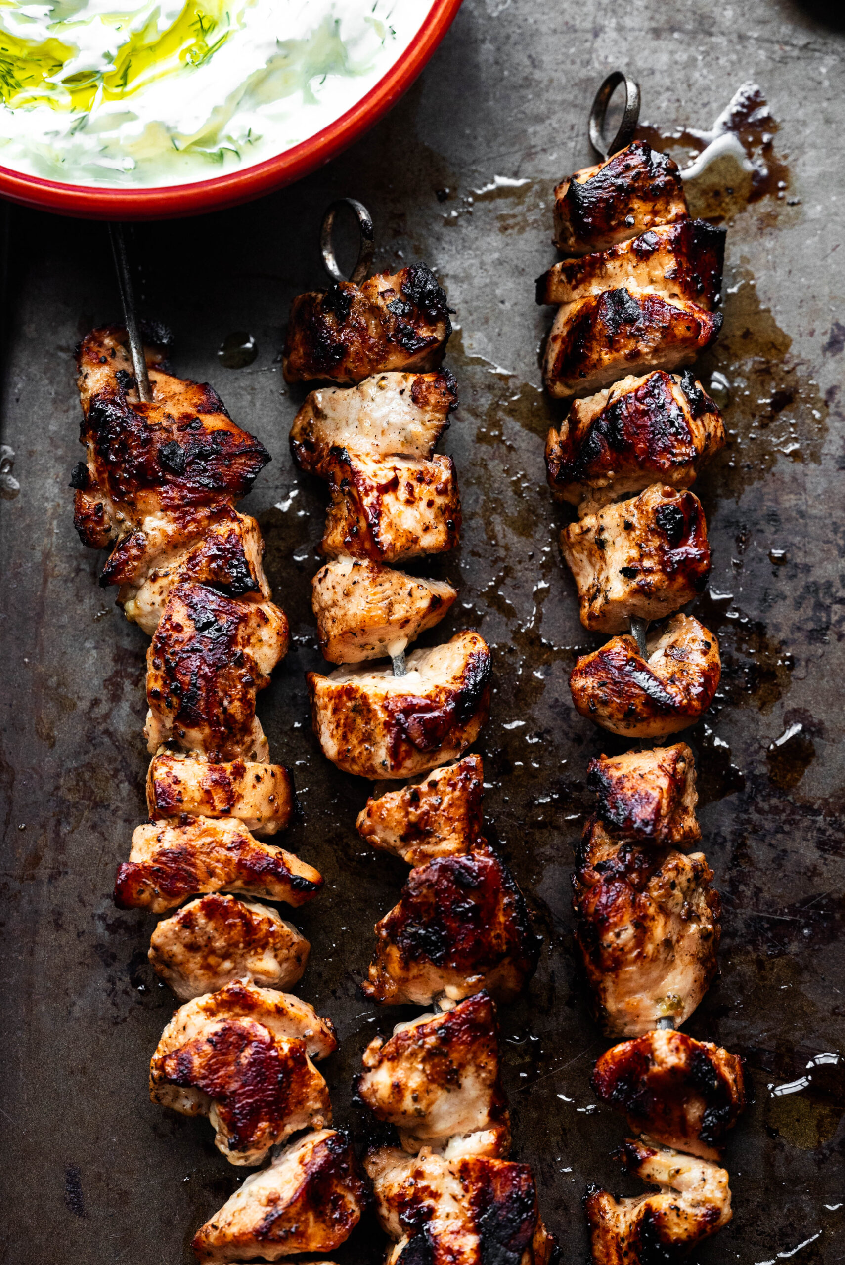 The grilled chicken on a sheet pan overhead shot. 