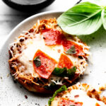 Pizza English Muffins on a speckled plate.