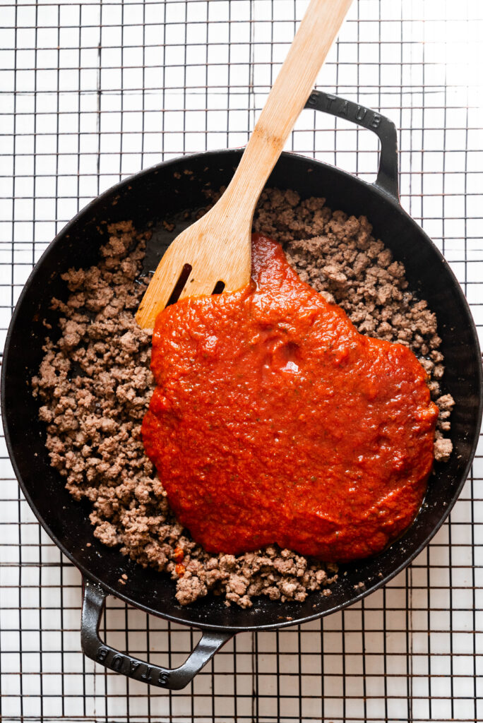 Process shot: browned beef with marinara.