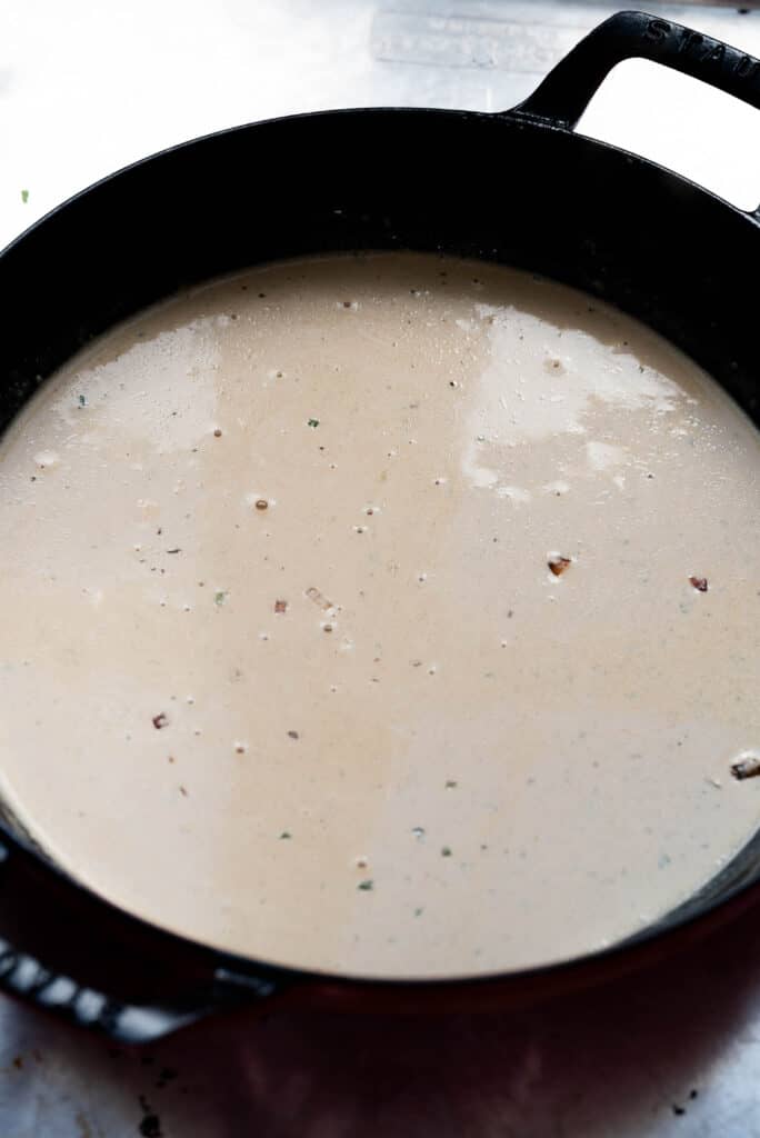 Process image: melted boursin and broth in a dutch oven. 
