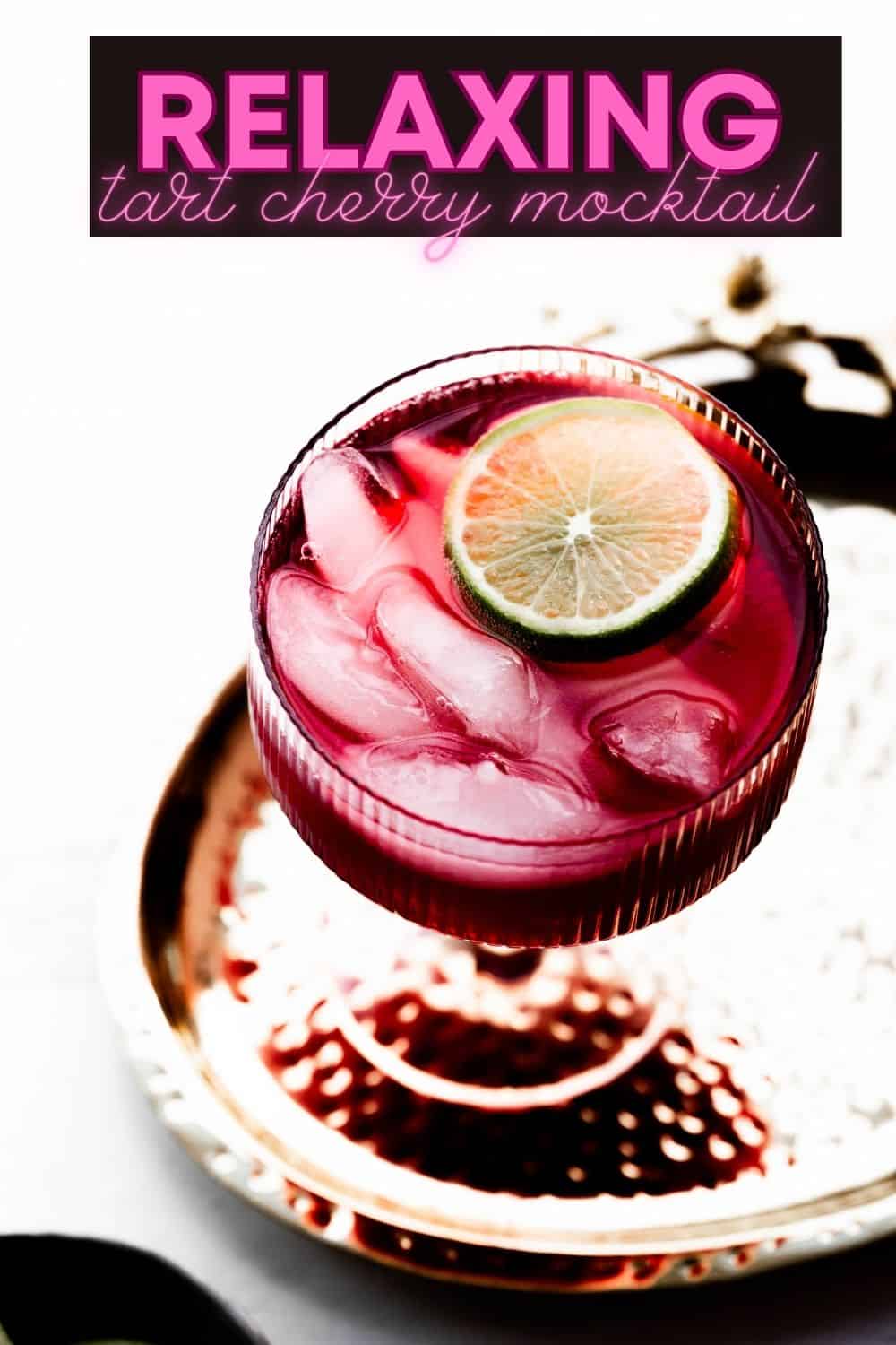 Pinterest pin with text overlay and an image of a mocktail in a pink glass. 