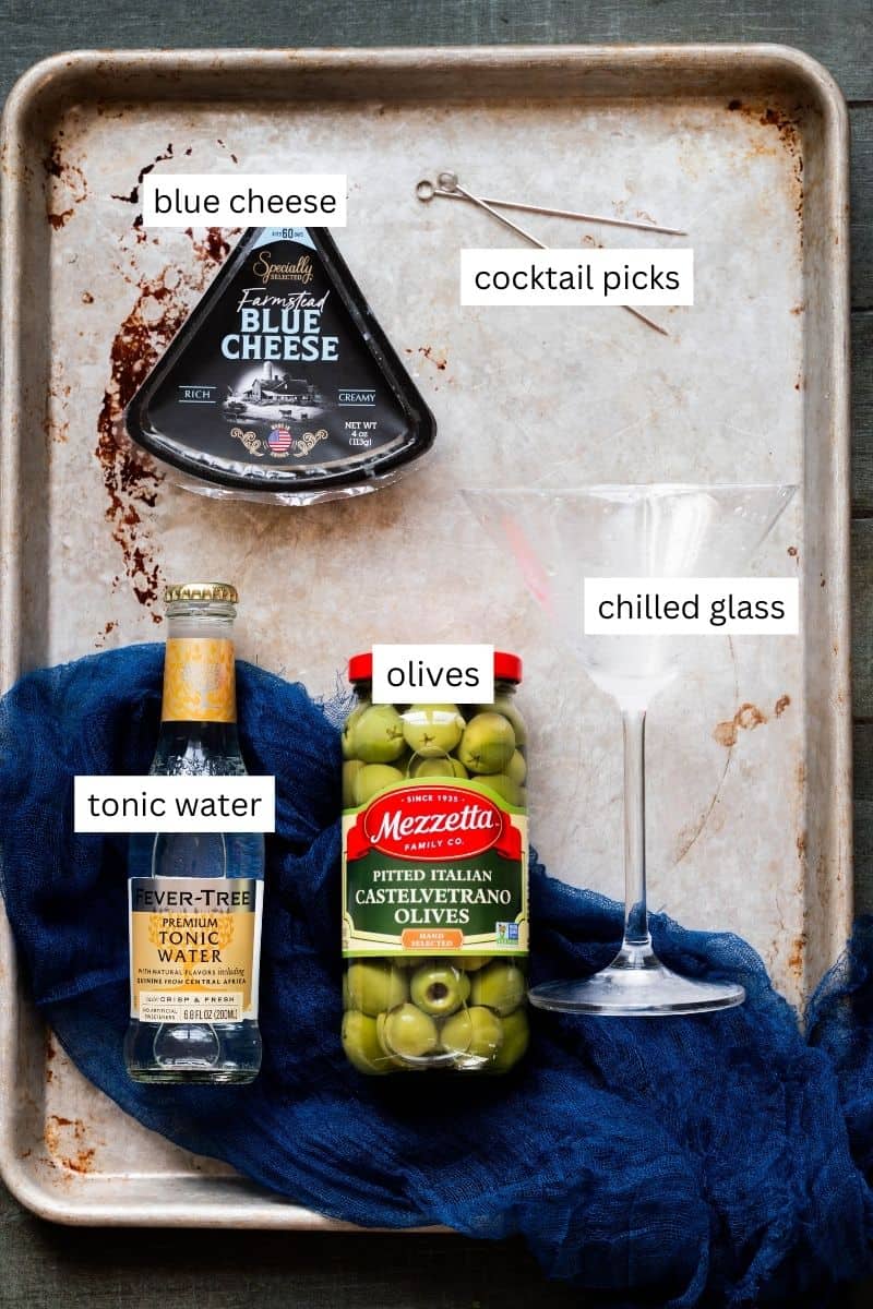 Ingredients needed, and labeled, that you need to make a dirty martini mocktail. 