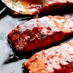 Dutch Oven Salmon with Glaze being spooned on.