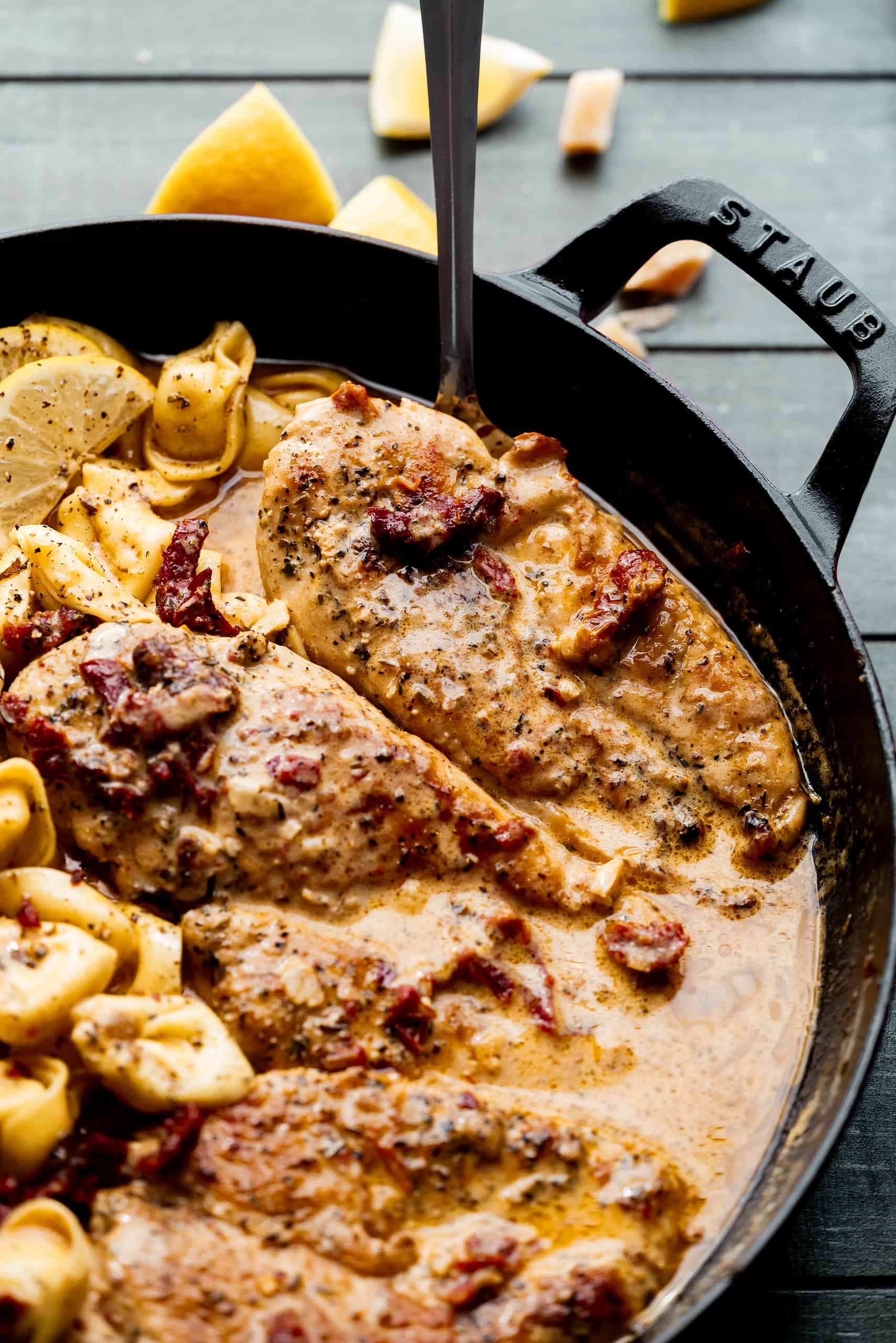 Close up image of chicken in sun dried tomato cream sauce. 