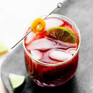 Blood Orange Hibiscus Mocktail with limes and orange garnish.