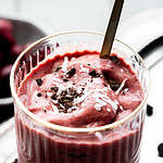 cherry mango smoothie on a gold plate.