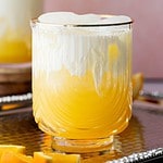 Close up image of orange soda with cream.
