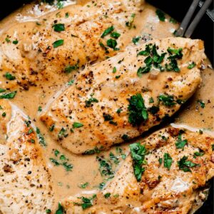 Maple bourbon chicken with parsley garnish.