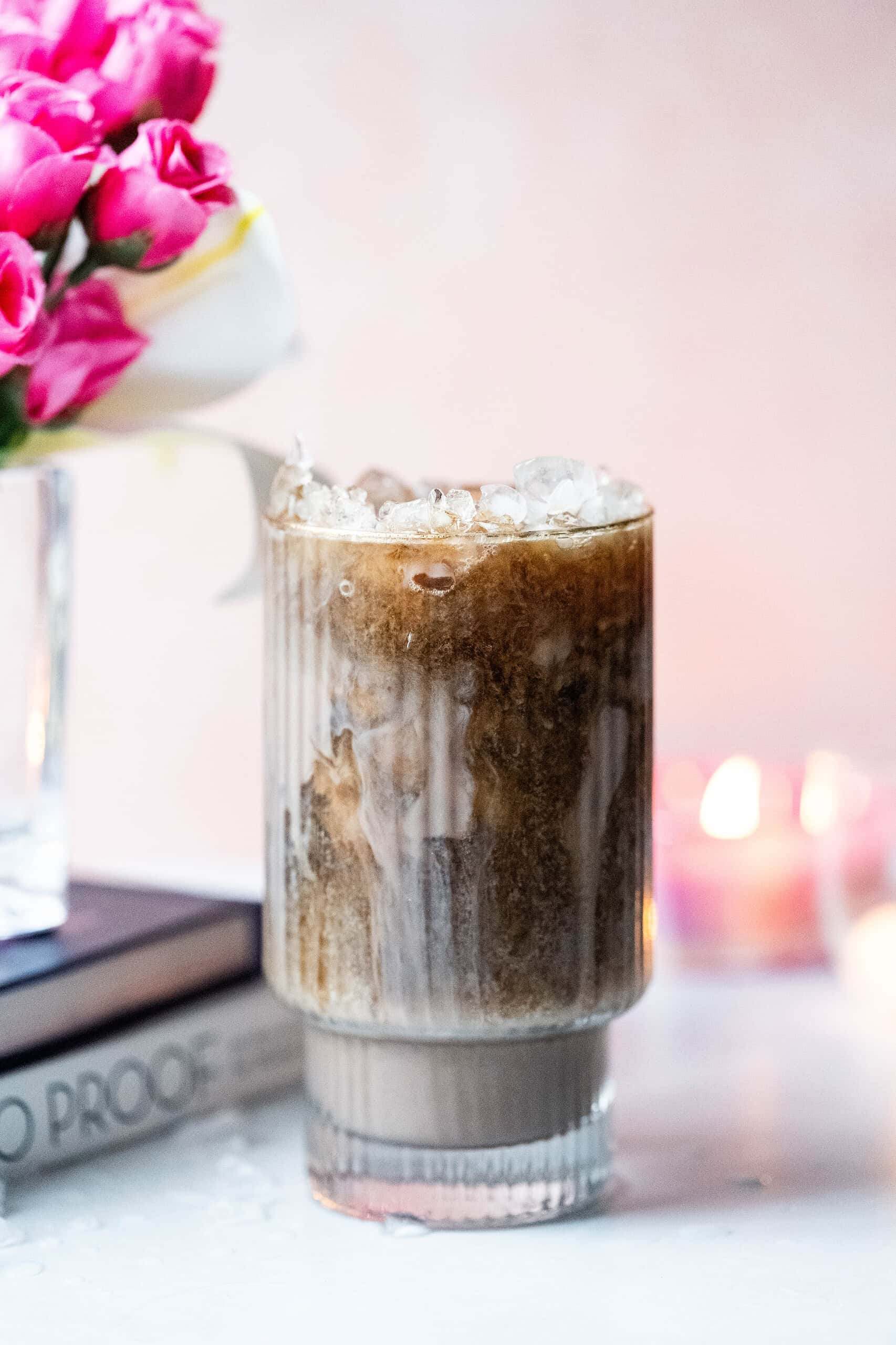 Fancy image of a dirty diet coke with pink flowers.