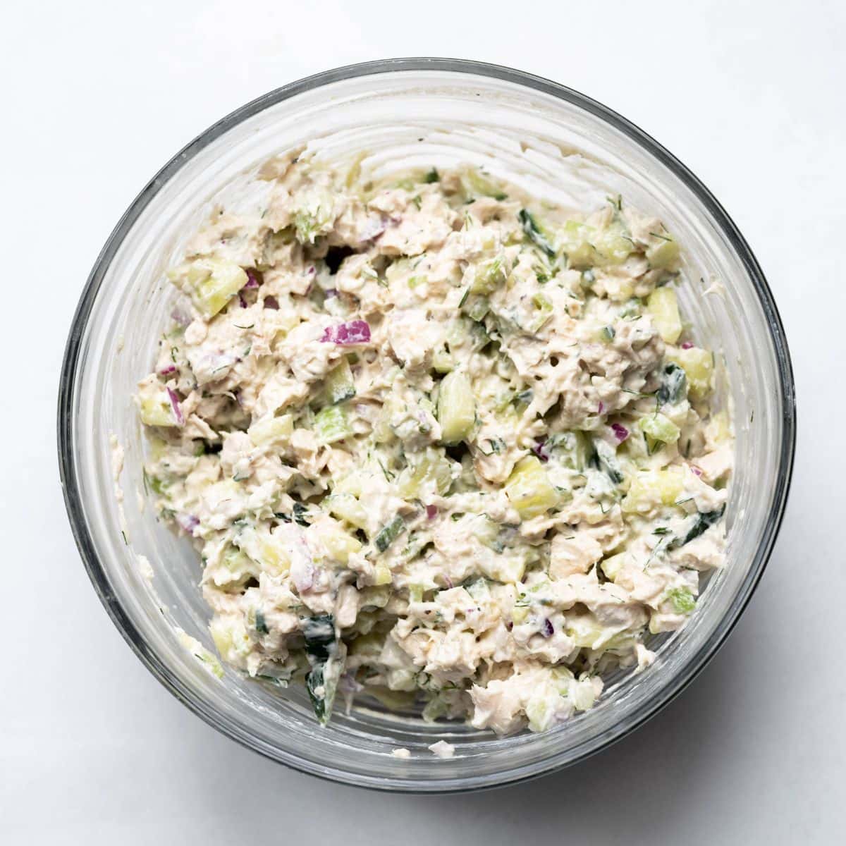 Hero image of cucumber dill chicken salad in a clear bowl. 