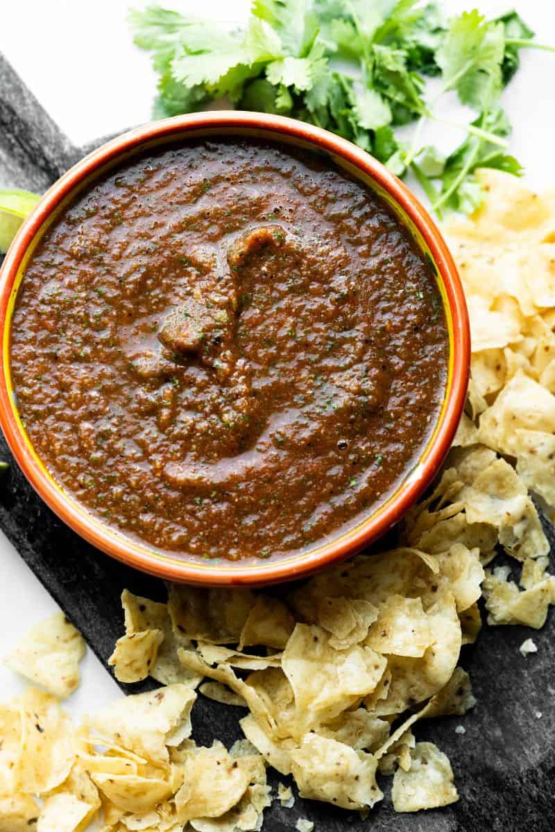 Overhead hero image of fire roasted tomato salsa in an orange bowl. 