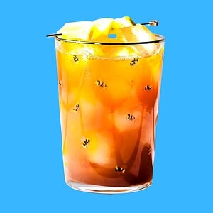 Hero image of dandelion detox mocktail on a blue background.