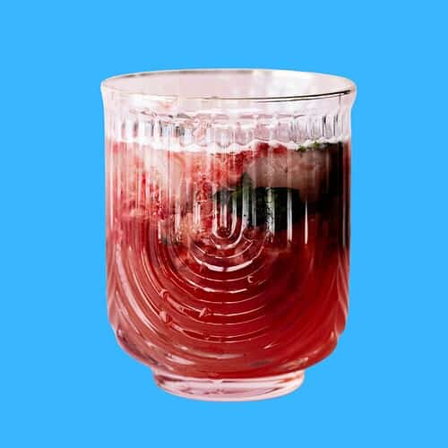 Featured image of strawberry mocktail on a blue background.