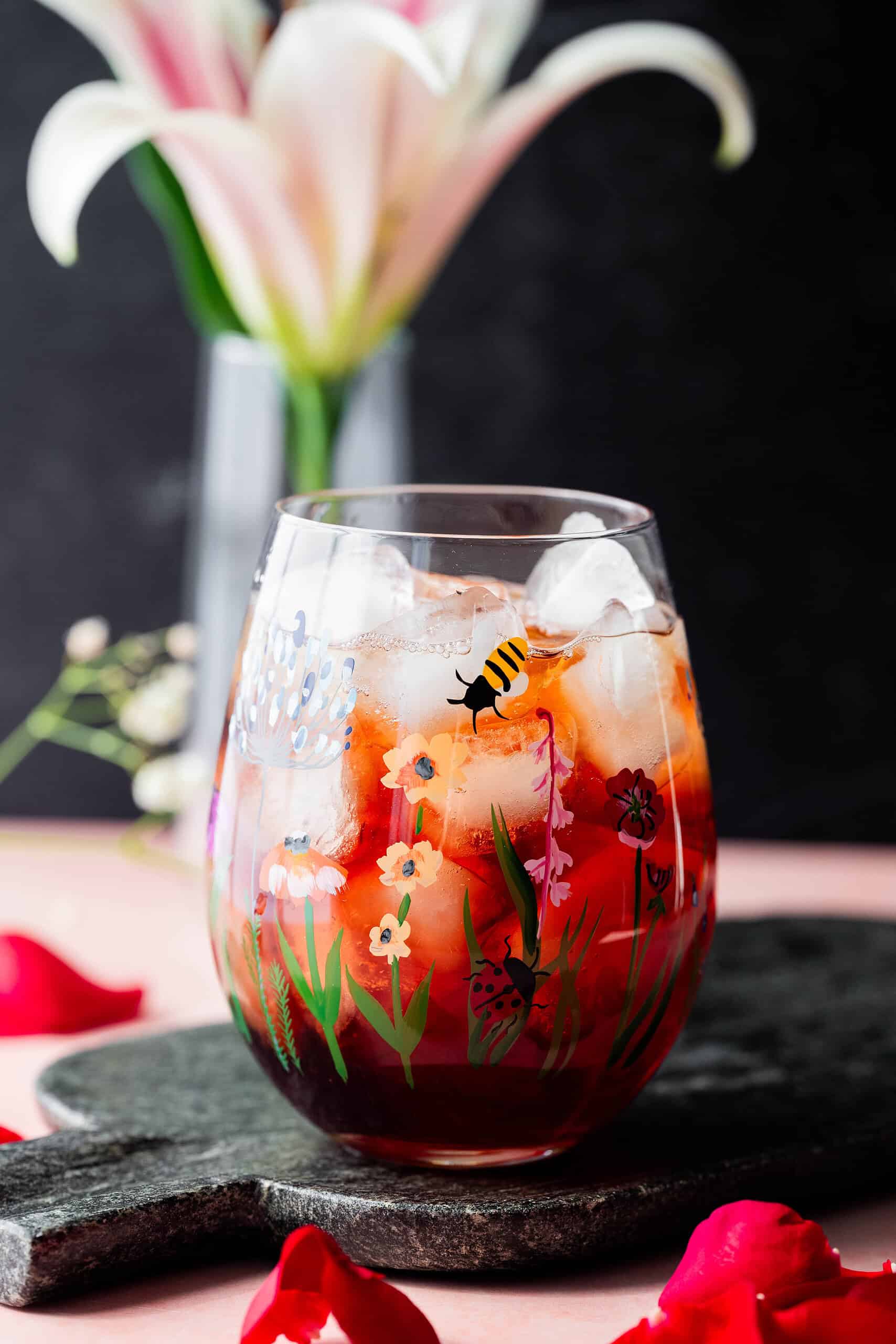 Hero image of a blueberry mocktail in a cute glass. 