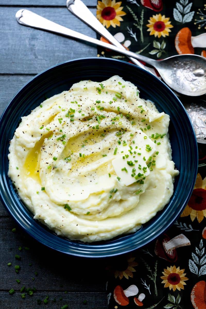 Overhead image of mashed potatoes with some silverware. 