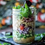 Hero image of a mason jar salad with a floral background.