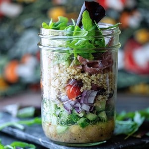Hero image of a mason jar salad with a floral background.
