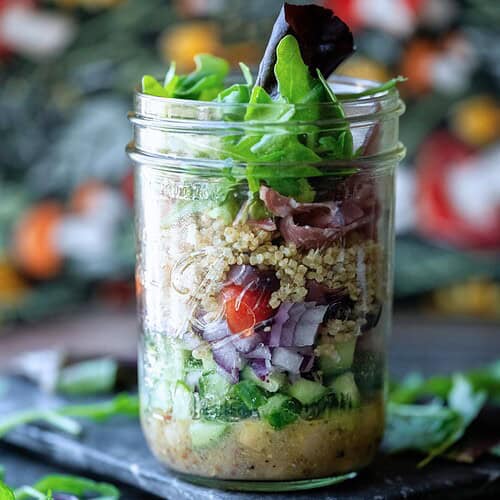 Hero image of a mason jar salad with a floral background.