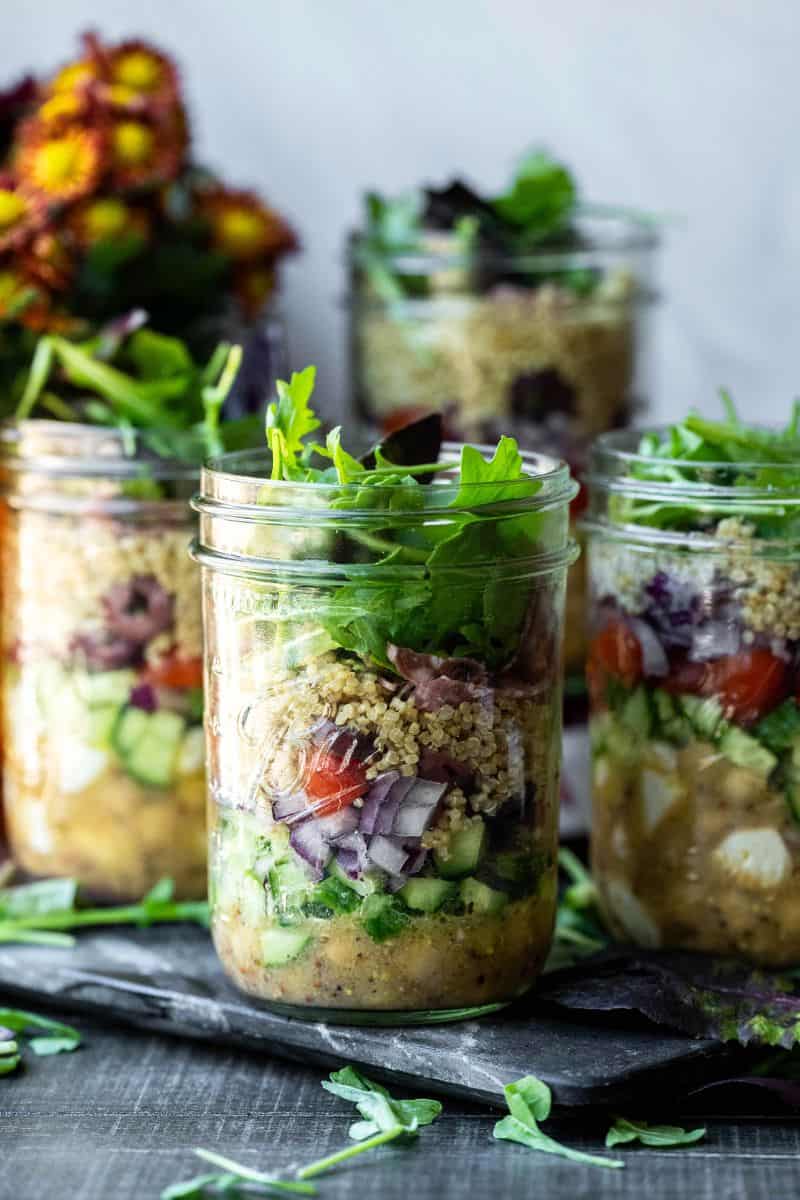 Image of multiple mason jar salads.