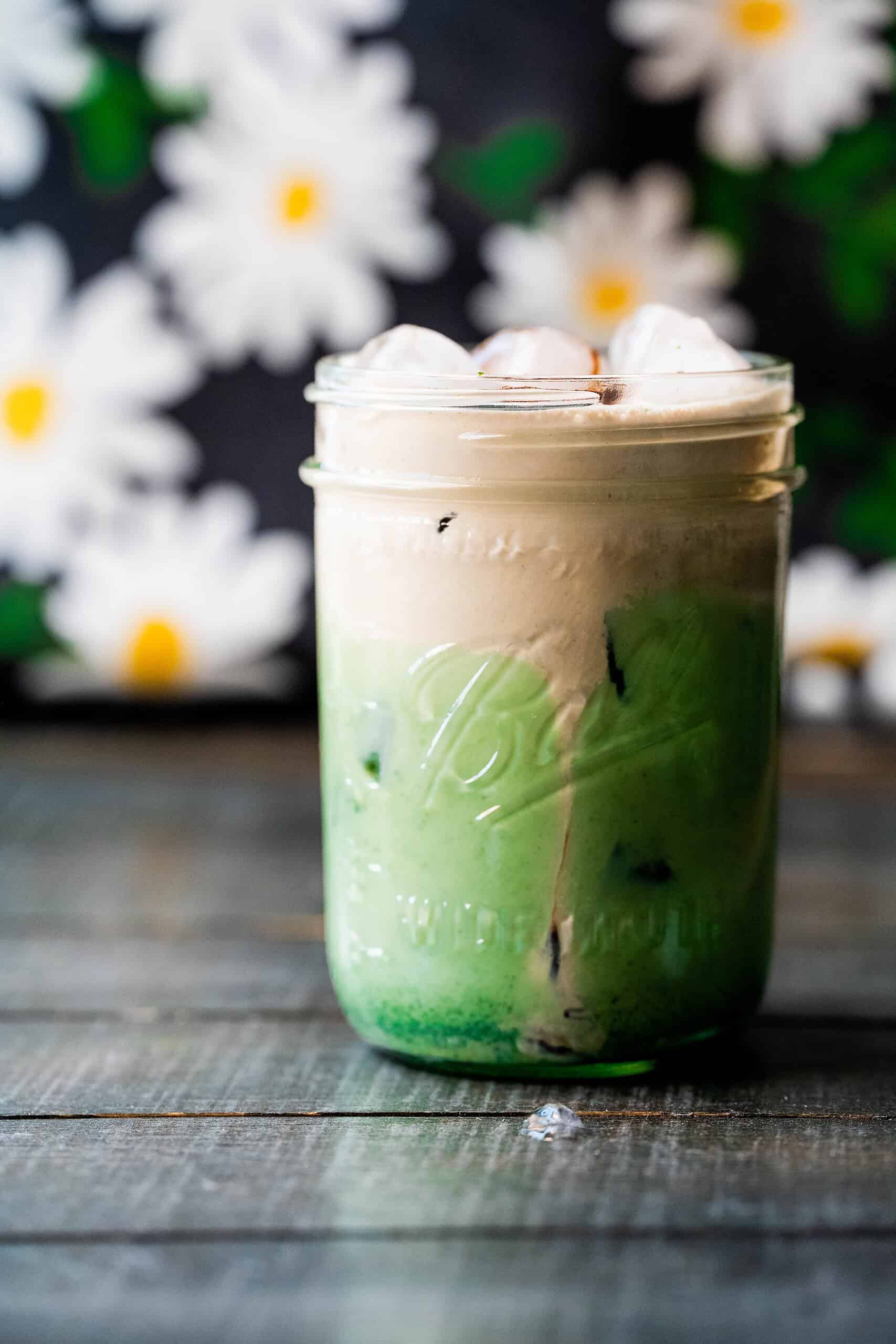 Up close image of iced matcha with chocolate topping. 