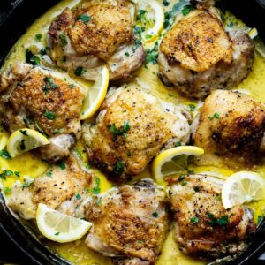 Hero image of dutch oven Boursin Chicken Thighs with Lemon Garnish.