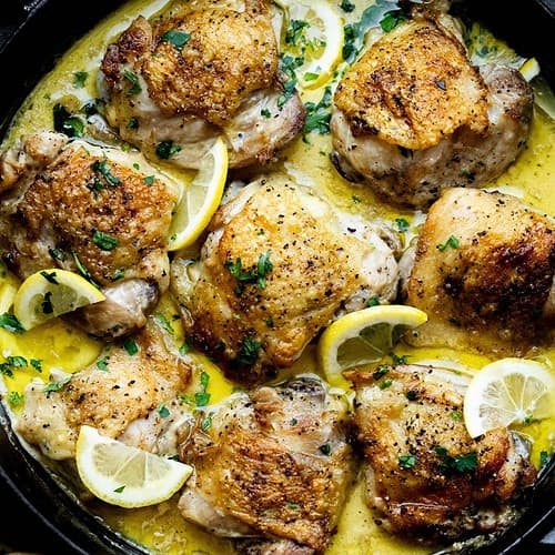 Hero image of dutch oven Boursin Chicken Thighs with Lemon Garnish.