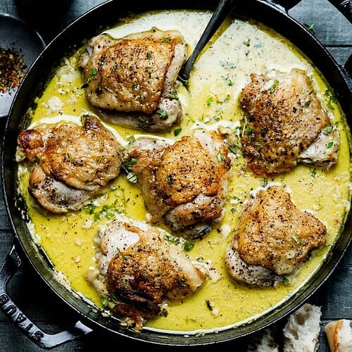 Creamy Mustard Chicken Thighs in a black pan.
