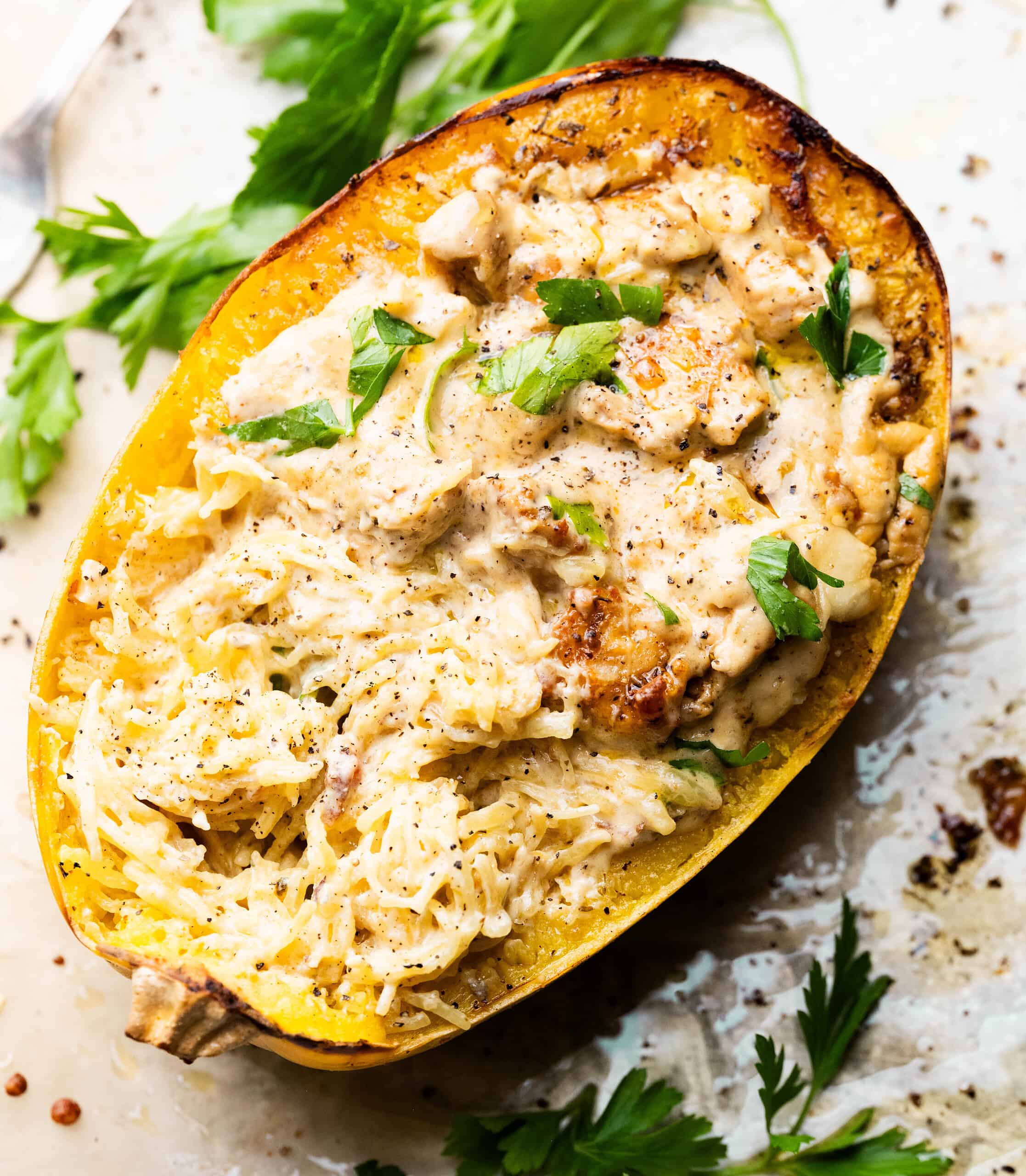 High protein chicken alfredo spaghetti squash on a sheet pan. 