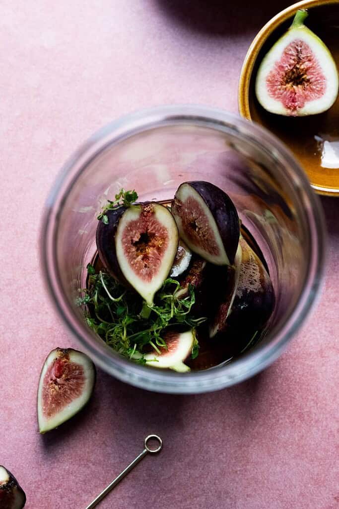 Figs in a jar with thyme, maple syrup.